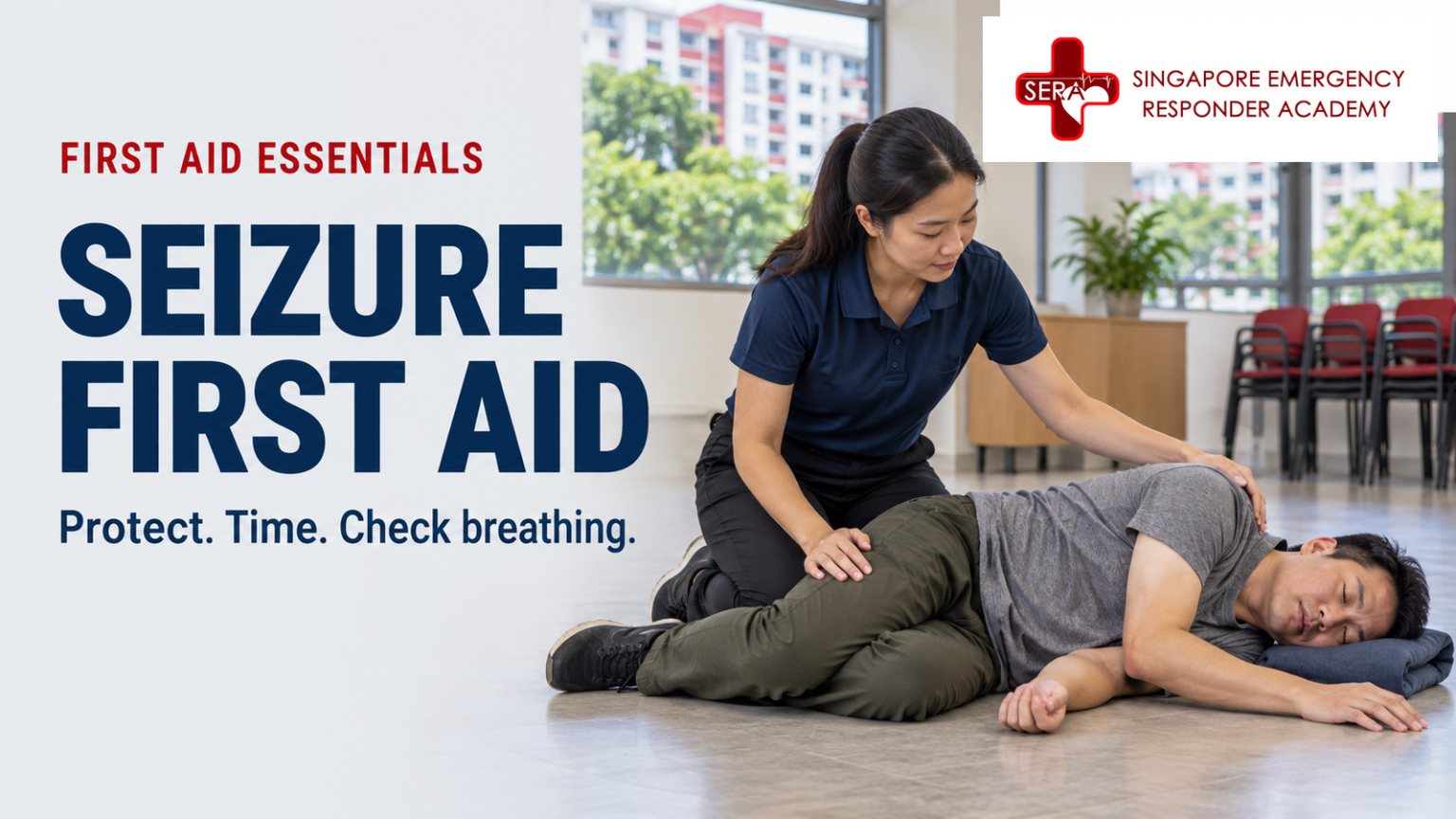 First aider supporting an adult resting on their side after a seizure in a Singapore community room.